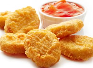 Chicken nuggets and sweet chili sauce isolated on white background